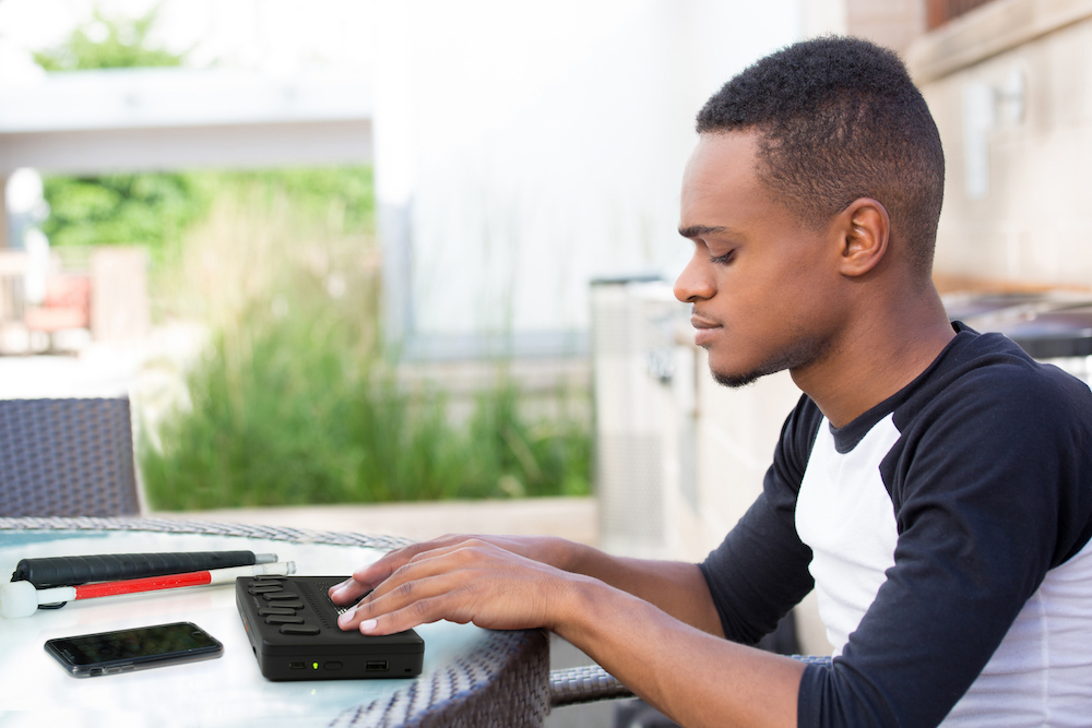 A student using the Humanware Brailliant 20X braille display, in a classroom setting.